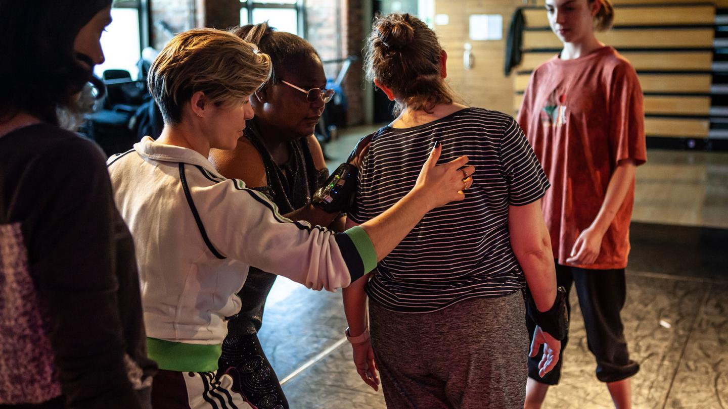 Group rehearsing and practicing while physically supporting each other