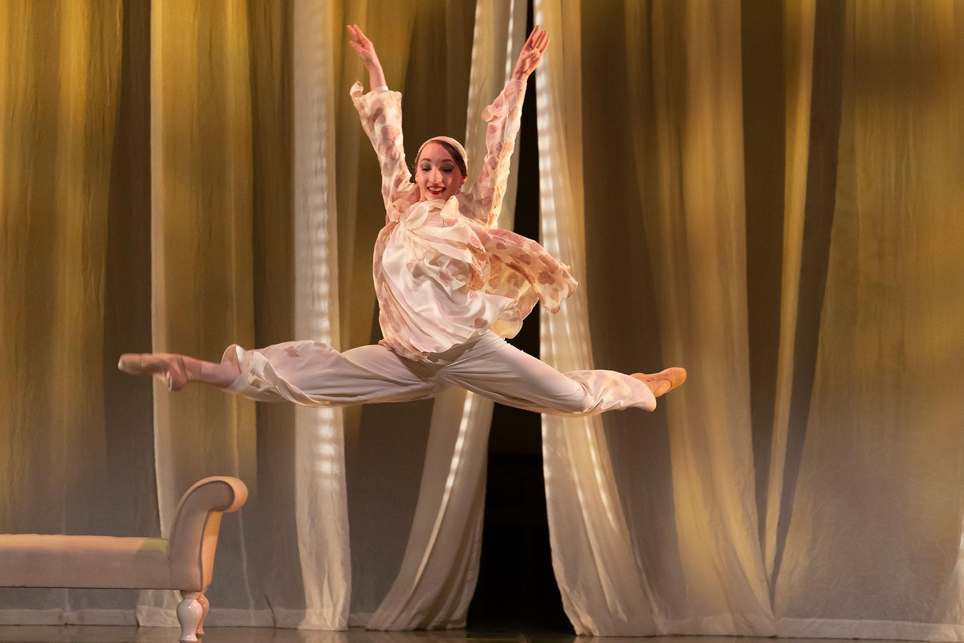 Heather Lehan as Jordan leaping across the stage in The Great Gatsby. Photo Emma Kauldhar