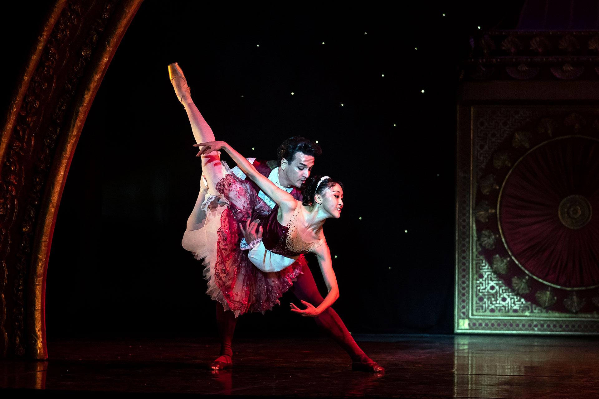 The Cavalier holds the Sugarplum Fairy in a Pas de Poisson, a fish dive.