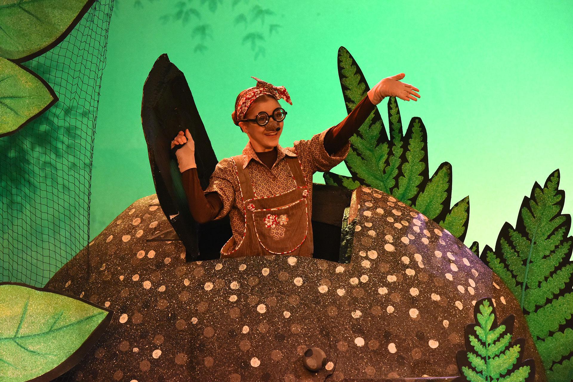 Molly the Mole emerges from her molehill waving