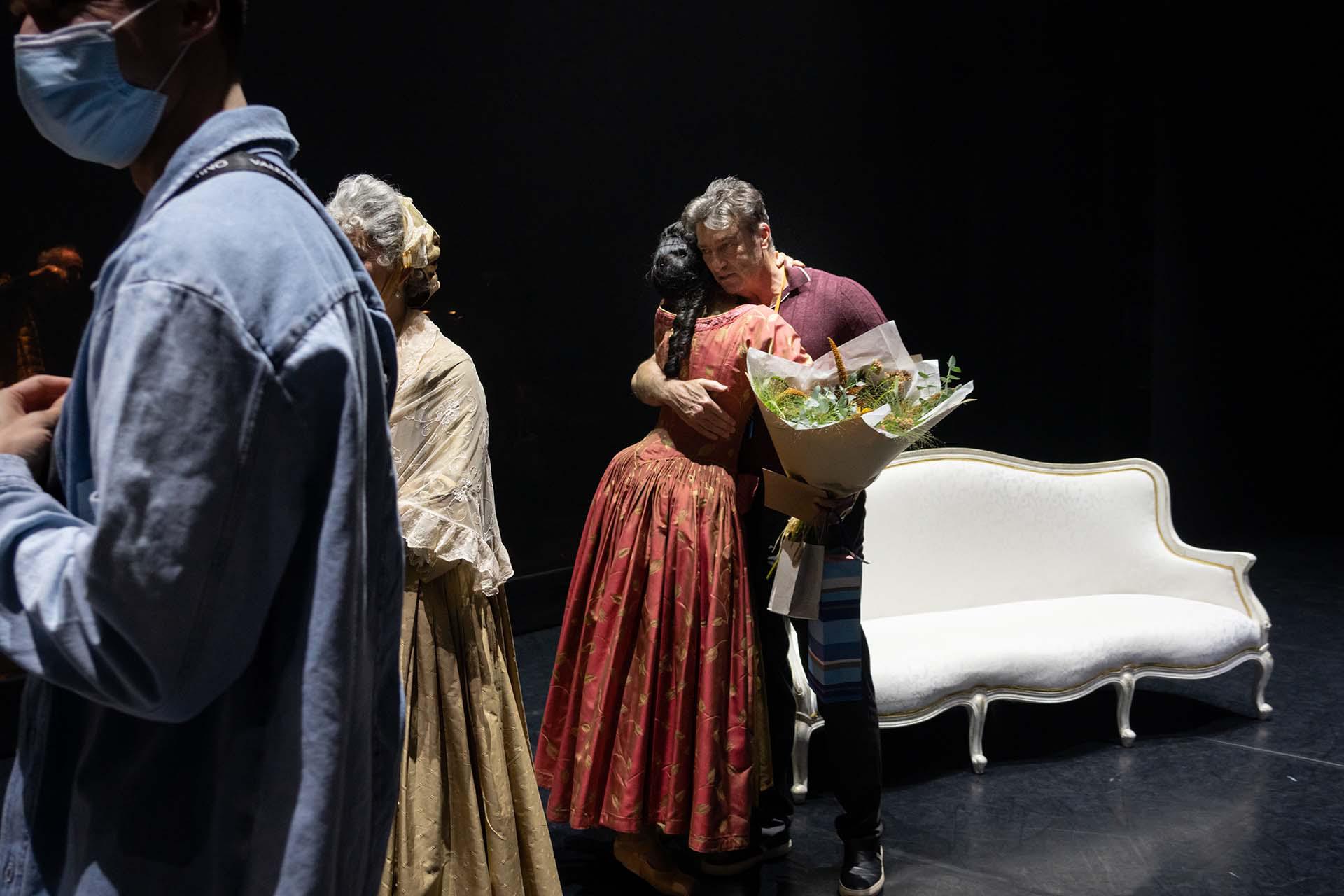 David hugs a dancer to say farewell