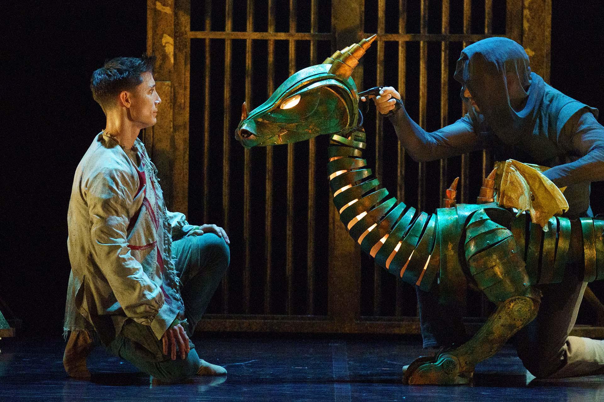 The dragon looks at Merlin, assessing him