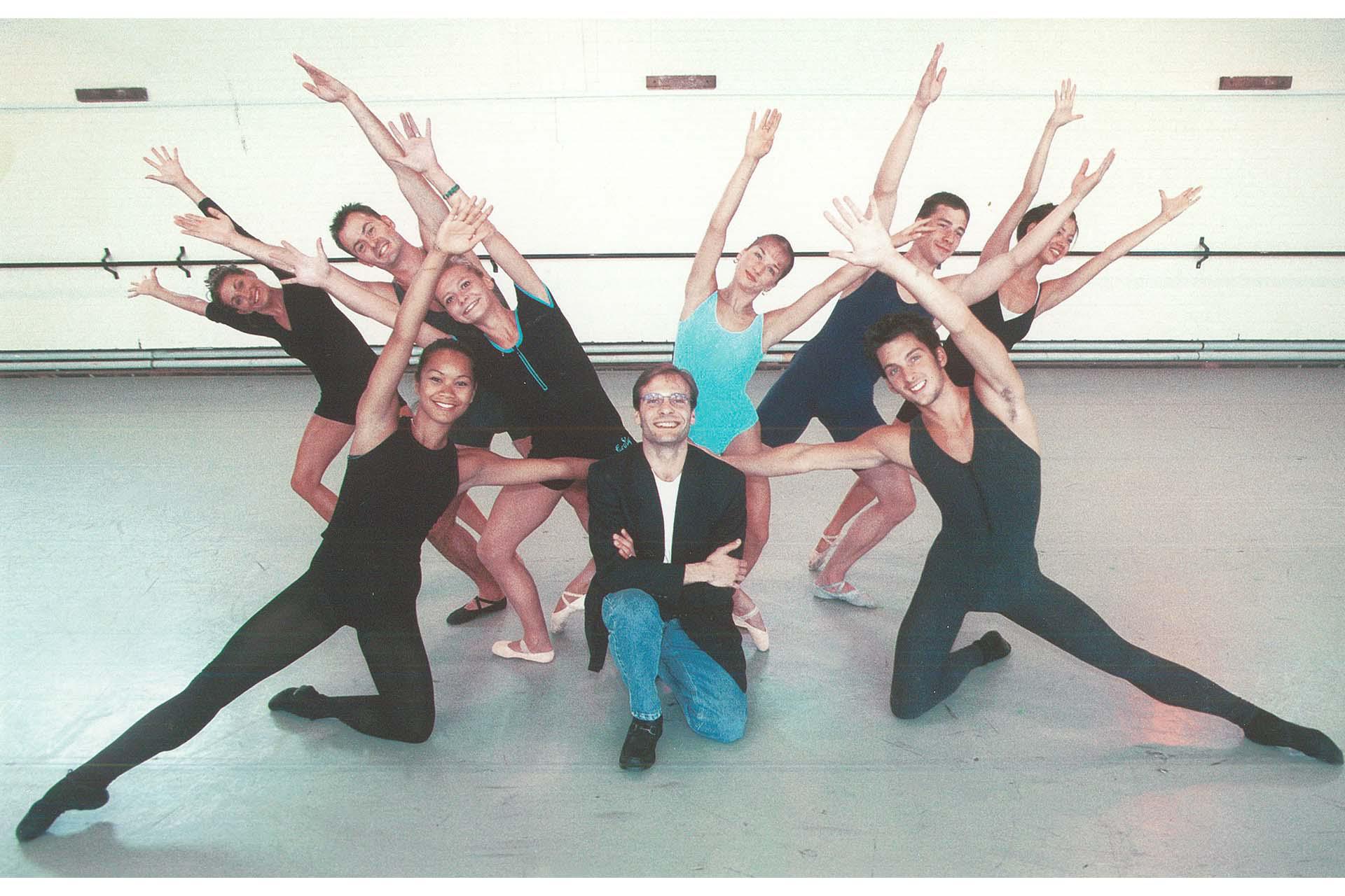 The Company celebrate Halifax PLC’s renewal of sponsorship with Stefano kneeling in the centre and dancers posing, arms outstretched, around him