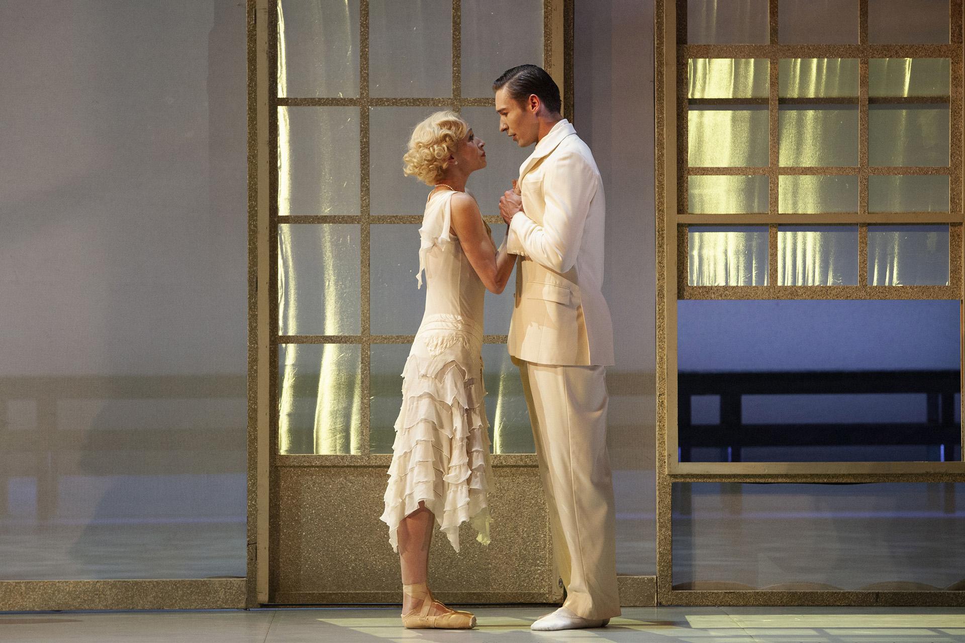 Daisy and Jay look lovingly at one another, both wearing white