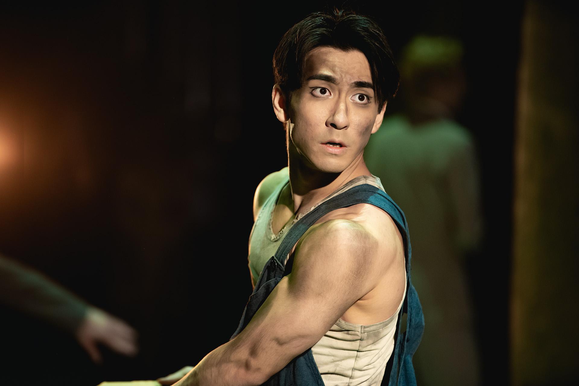 George Wilson looking over his shoulder with a worried expression on his face