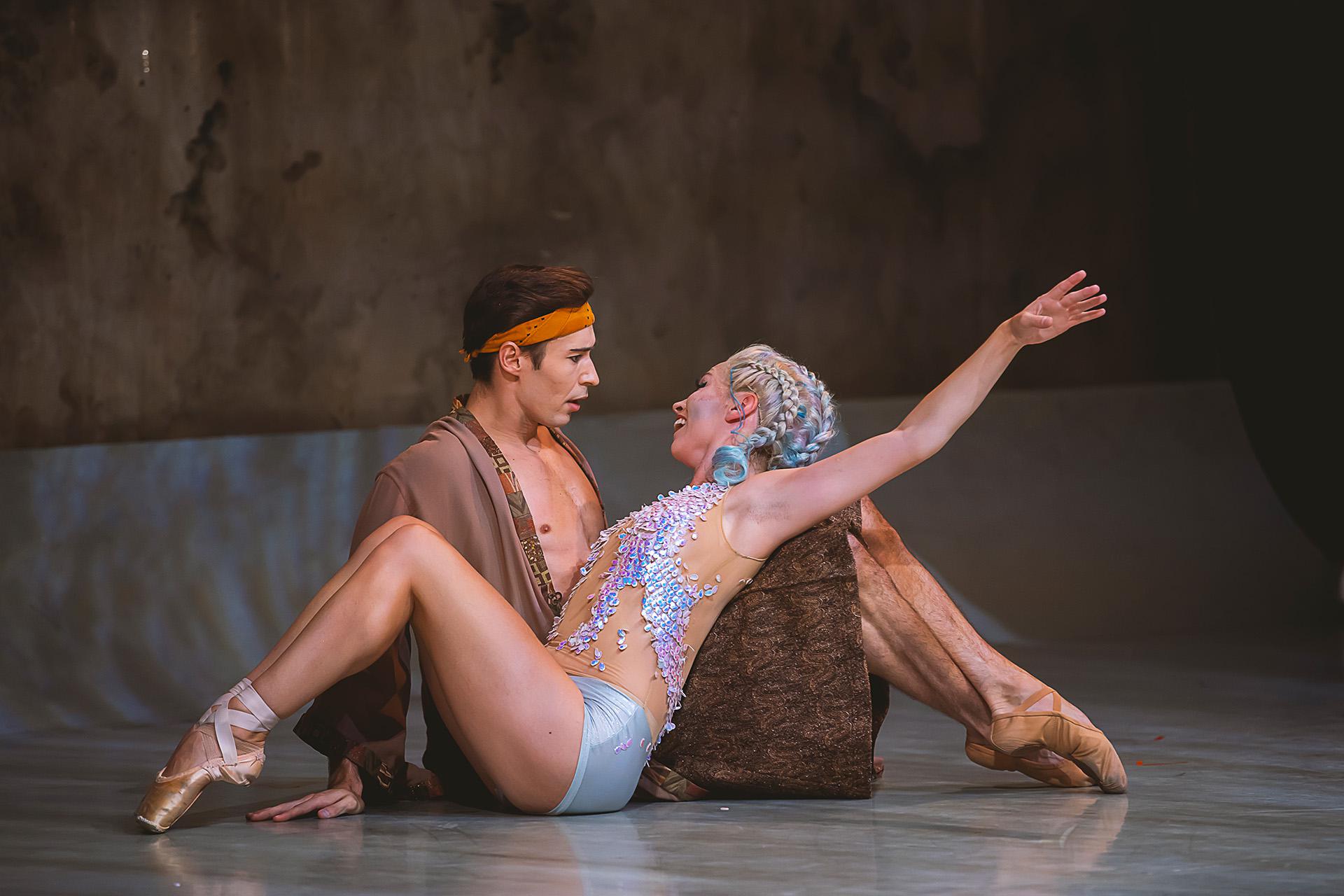 Prince Adair sits in shock as a newly legged Marilla leans against his legs