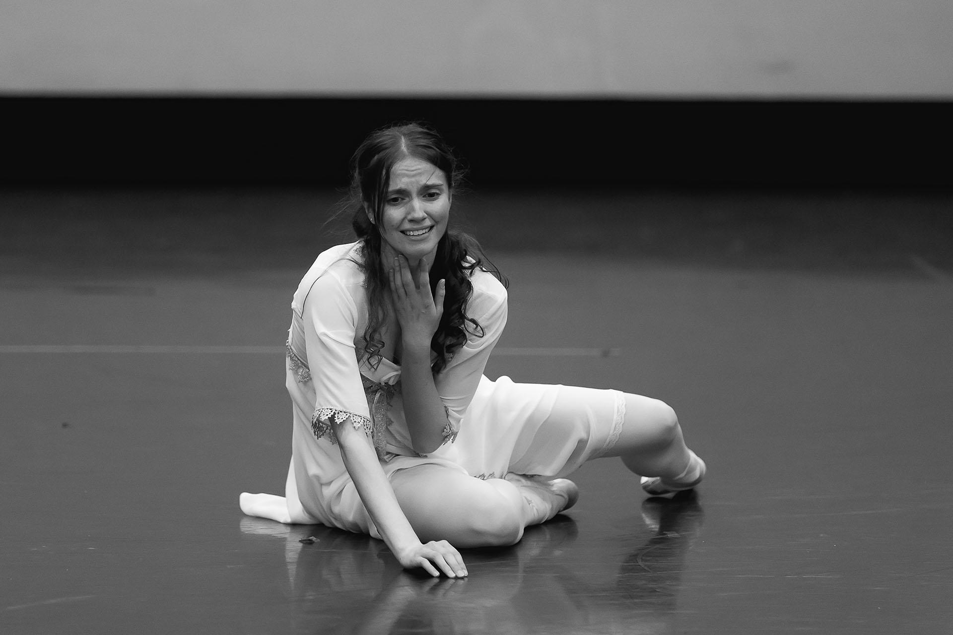 Black and white photo of women devastated and crying sat on the floor