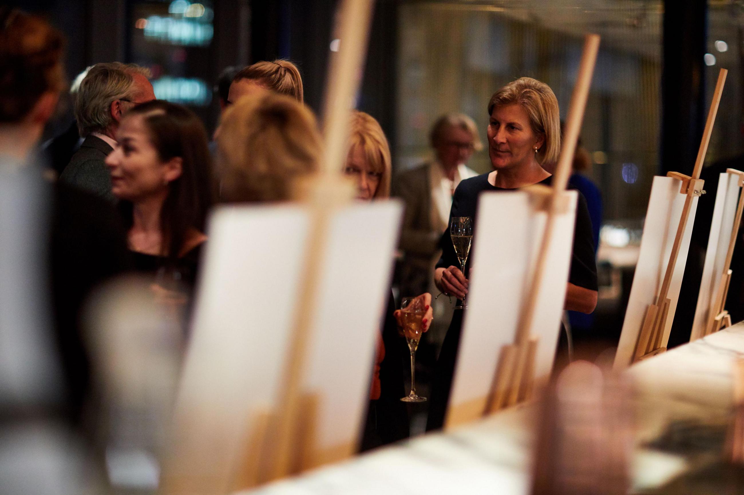 Supporters chatting and enjoying a display at a Benefactor Event