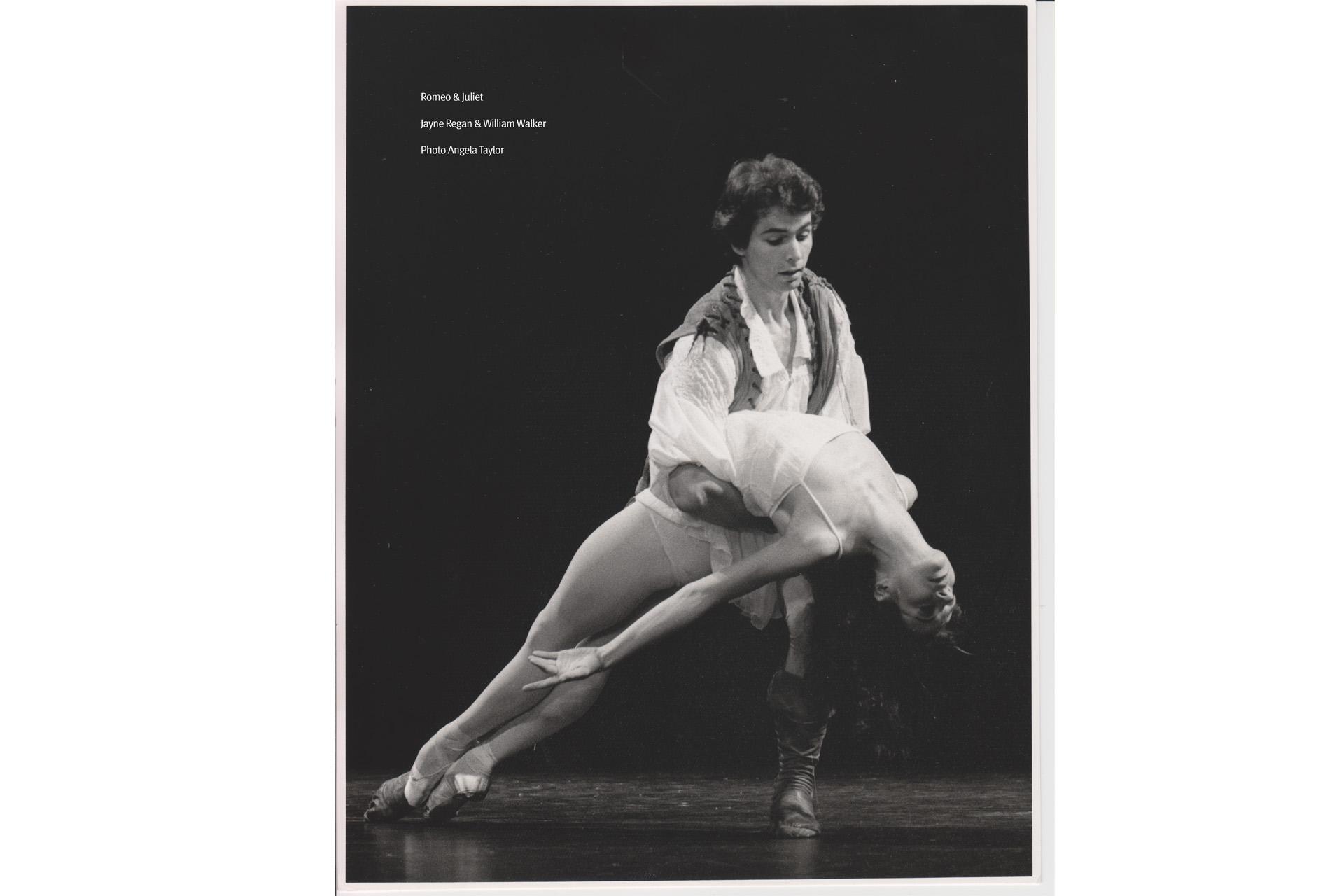 Black and white photo of two dancers, one holding the other as she falls backwards