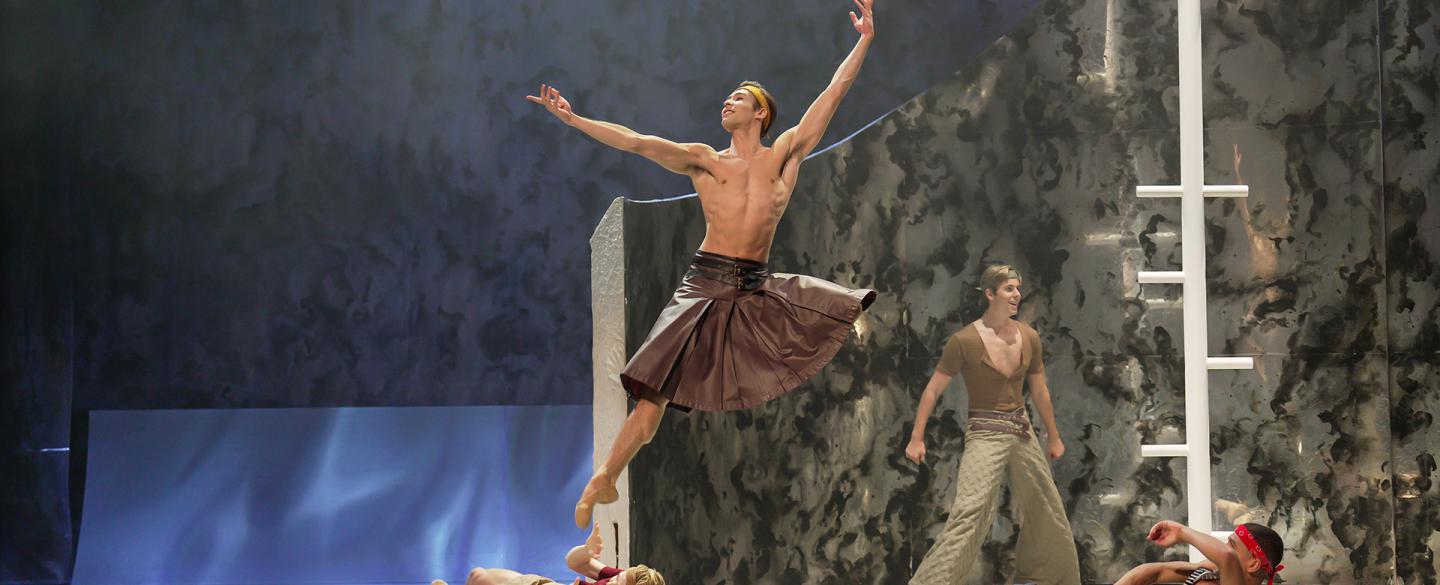 Wearing a leather kilt, Prince Adair leaps high on his ship