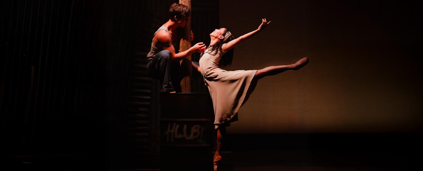 In the glow of a streetlight, two dancers dressed plainly show their love through dance