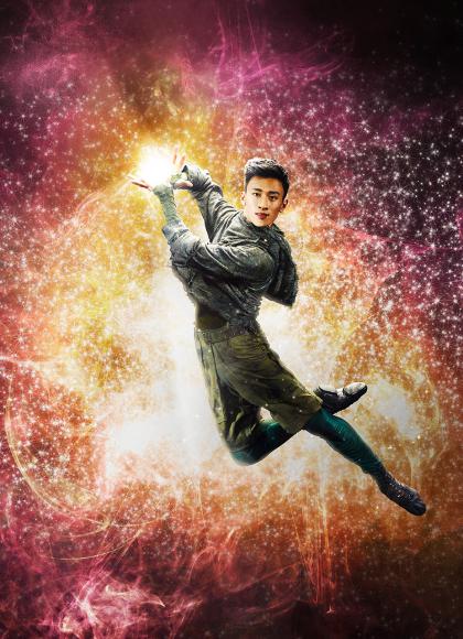 Dancer leaps holding light in his hands. 