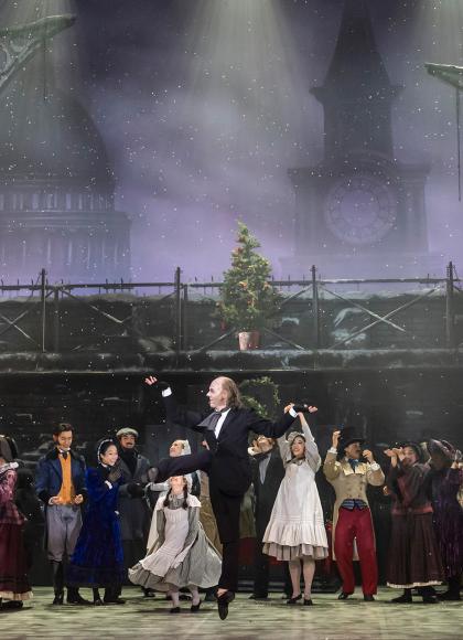 A dancer on stage jumping up in joy