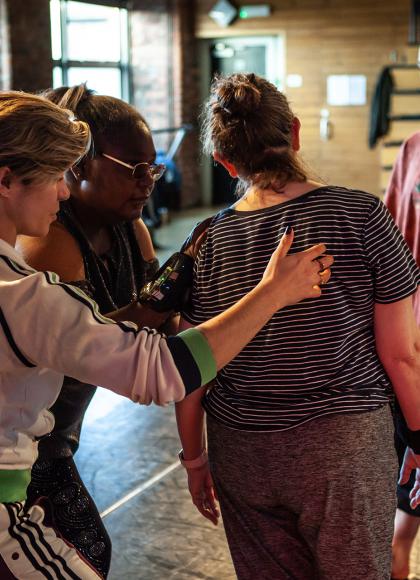 Group rehearsing and practicing while physically supporting each other