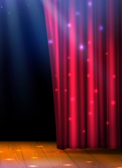A stage with wooden floor, red curtains parting and the set behind dark, full of possibilities
