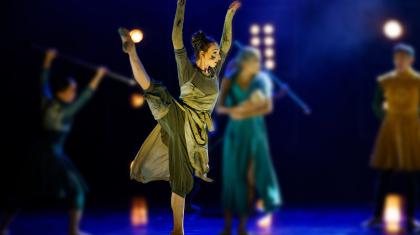 The Blacksmith, one leg raised straight and hight, her clothes ragged, her face dirty