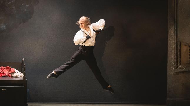 Scrooge in the morning after his spectral visitors leaps joyously while getting dresses